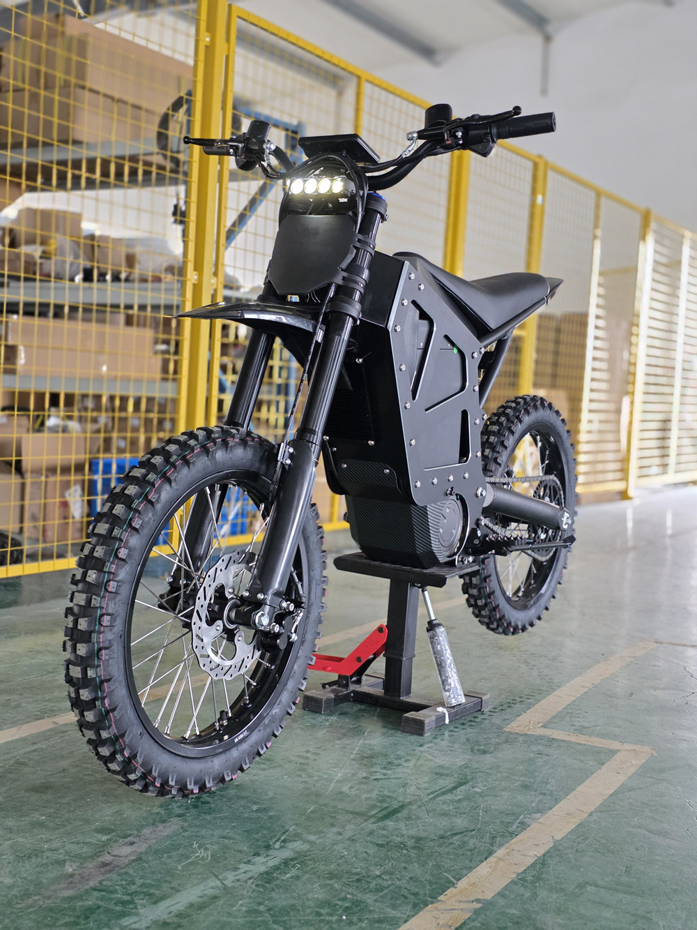 Black MD-6X mid-drive electric dirt bike featuring a massive 72V 58Ah battery, side profile view